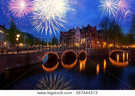 Famous Canals And Bridgres Of Amsterdam In Night With Fireworks, Netherlands