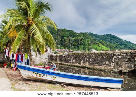 Portobelo, Panama  - May 28, 2016: Drying Laundry And A Fishing Boat In Portobelo Village, Panama