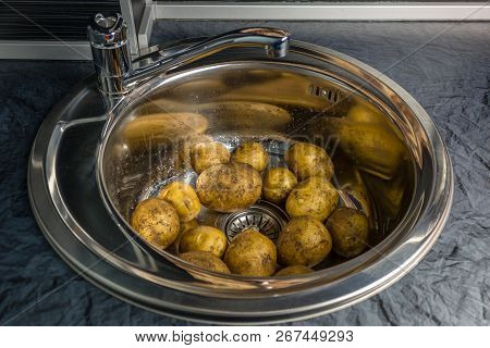 Wash The Raw Potatoes In The Sink. Symbolizes Rural Home Cooking And Garden. Healthy Food Lifestyle.