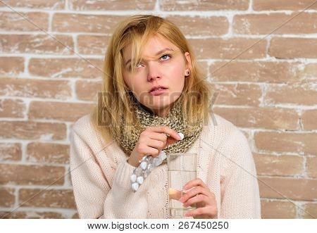 Pills For Breaking Fever. Take Medications To Reduce Fever. Woman Tousled Hair Scarf Hold Glass Wate