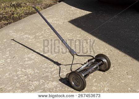 A Side View Look At A Reel Lawnmower After 90 Percent Of The Paint Was Removed