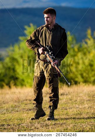 Hunter With Rifle Looking For Animal. Hunting Shooting Trophy. Mental Preparation For Hunting Indivi