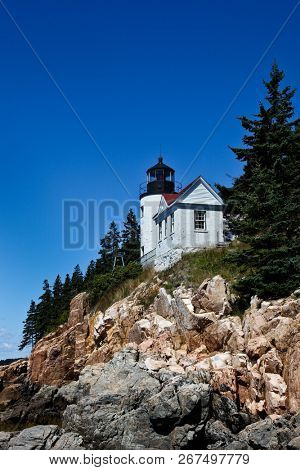 BASS HARBOR, MAINE - AUGUST 7, 2010: Bass Harbor Lighthouse in nice day with blue sky overlooking Atlantic Ocean in Maine.