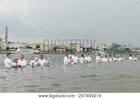 Kiev, Ukraine. July 22 2018 Pastors Baptize People In The River. Mass Water Baptism On The Beach.