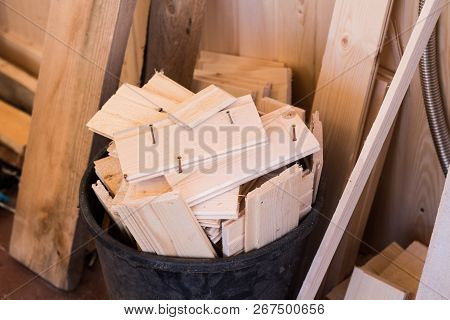 Construction Waste In The Repair Of A Wooden House. Light Wooden Bars With A Basket