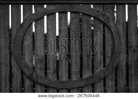 A Wooden Fence With An Oval Shape Attatched To The Fence Black And White