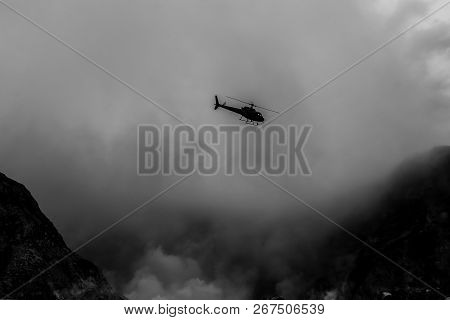 A Helicopter Flying Through The Smoke On White Island, New Zealand