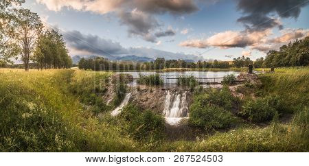 Strba Pond Lit By Golden Light At Sunset With High Tatras Mountains In Background, Slovakia.