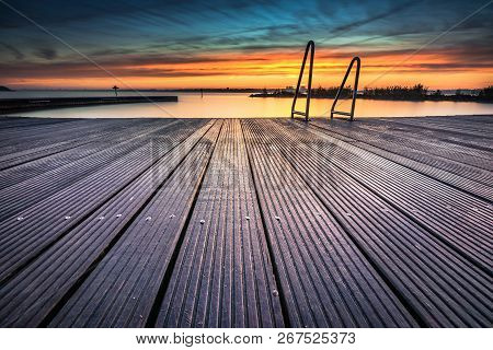 Architecture Outdoor Swimming Pool At The Lake With Metal Aluminum Swimming Stairs During An Impress