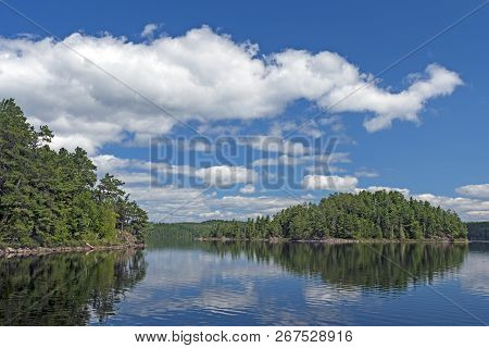 Puffy Clouds In Summer On Cache Bay In The North Woods Of Quetico Provincial Park In Ontario, Canada