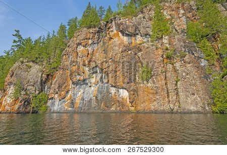 Colorful Cliffs Along  Ottertrack Lake In The North Woods Of Quetico Provincial Park In Ontario