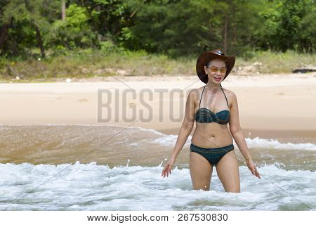 Woman Enjoy With Bikini Hat And Wave On Beach At Bang Beot Beach, Chumphon Province Thailand