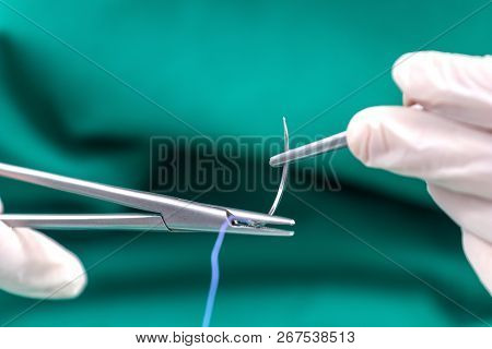Doctor Holding Surgical Forceps Suture Needle, Suturing Material
