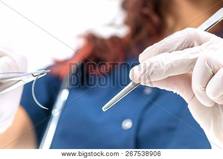 Doctor Holding Surgical Forceps Suture Needle, Suturing Material