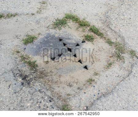 The Drain Hatch, Amid The Asphalt Hatch With Holes