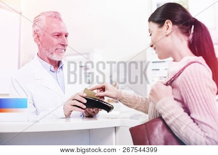 Customer Swiping Her Credit Card Buying Prescribed Pills