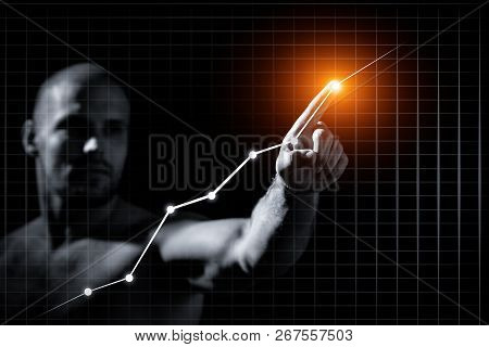 Young Man In Growth Concept With A Graph.serious Man Drawing Strategy On Virtual Screen On Dlack Iso