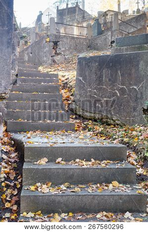 Dark Stairway Made Of Stone With Leaves On Cemetery, Uphill. Autumn.