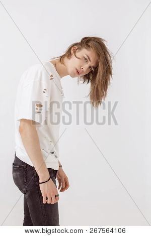 Handsome Young Guy Posing In Studio Against Isolated Background. Fashion Portrait Of Young Man In St