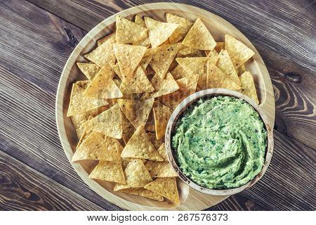Guacamole With Tortilla Chips On The Wooden Tray