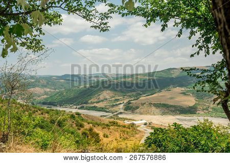 Landscape With Mountain And River With Natural Tree Leaves Border Or Frame. Place For Copyspace.