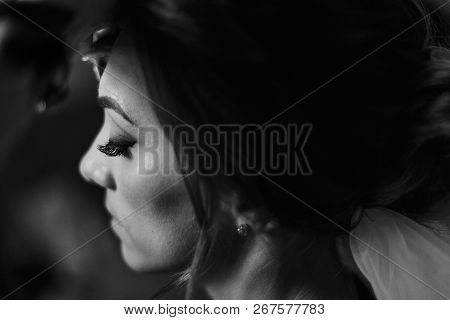 Makeup Artist Doing Brows And Applying Eyeshadow On Bride Face Close-up. Stylish Bride Getting Her M