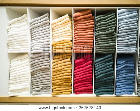 Multi-colored T-shirt Folded In The Lining Of The Shopping Mall.