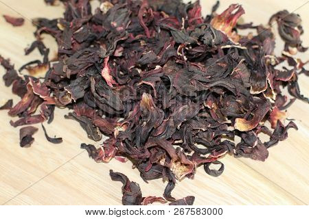 Dry Carcade Sudanese Rose On Wooden Desk