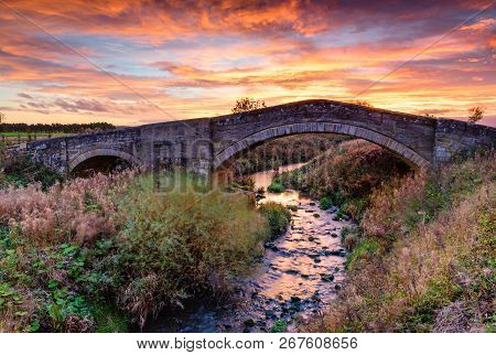 River Blyth Under Bellasis Bridge, The Humped-back Stone Bridge Is Grade 2 Listed, Seen Here At Suns