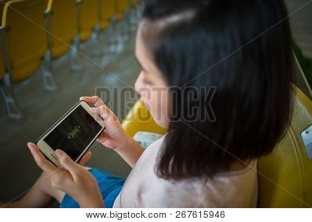 Zhuhai, China - September 28, 2018: Young Woman Playing Rov Online Computer Game On Smartphone. Teen