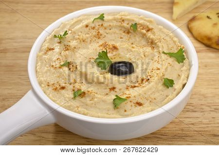 Middle Eastern Dip Hummus, Drizzled With Olive Oil, Sprinkled With Paprika And Scattered With Parsle