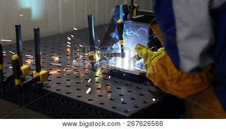 Worker Cutting Metalsheet By Acetylene Torch With Bright Sparks