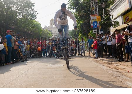 Kolkata, West Bengal, India - March 1st 2015 : Cyclist Boy Showing Off Bicycle Skills At Park Street