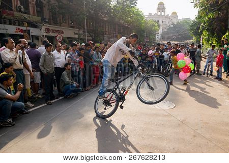 Kolkata, West Bengal, India - March 1st 2015 : Cyclist Boy Showing Off Bicycle Skills At Park Street
