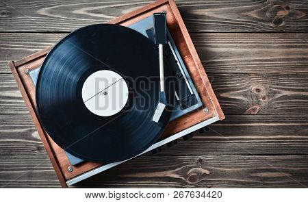 Vinyl Player With Plates On A Wooden Table. Entertainment 70S. Listen To Music. Top View.