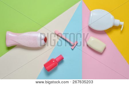 Products For The Care Of Body, Hair And Personal Hygiene On A Multi-colored Paper Background. A Bott
