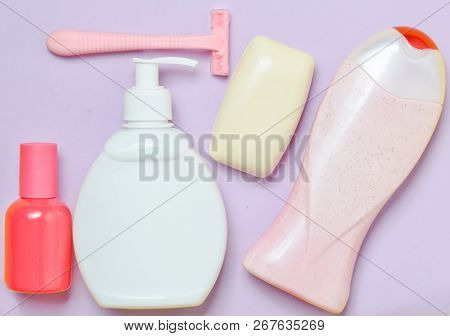 Products For The Care Of Body, Hair And Personal Hygiene On A Purple Pastel Background. A Bottle Of 