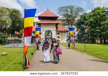Kandy, Sri Lanka - July 19, 2016: Buddhist Devotees Visit Temple Of The Sacred Tooth Relic During Po