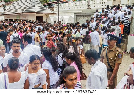 Kandy, Sri Lanka - July 19, 2016: White Clothed Buddhist Devotees Wait In A Queue At The Entrance To