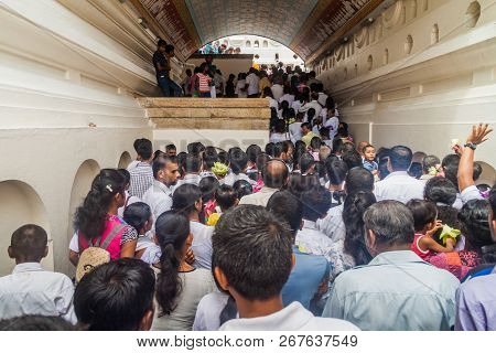Kandy, Sri Lanka - July 19, 2016: White Clothed Buddhist Devotees Wait In A Queue At The Entrance To