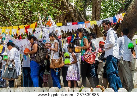 Kandy, Sri Lanka - July 19, 2016: White Clothed Buddhist Pilgrims Visit Wel Bodiya With Bodhi Tree D