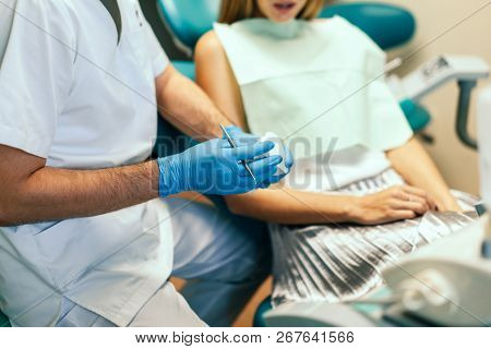 Dentist Examine Female Patient With Braces In Denal Office.