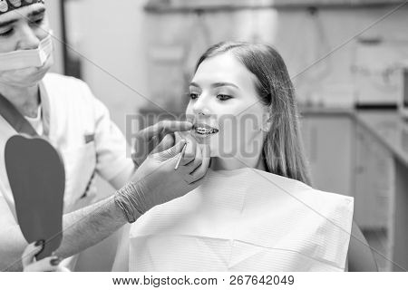 Dentist Showing Result Of Treatment For The Patient.