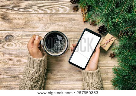 Female Hands Holding Modern Smartphone With Mosk Up And Mug Of Coffee On Wooden Vintage Table With C
