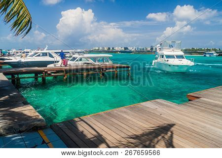 Hulhule Island, Maldives - July 11, 2016: Boats At The Harbor Next To Ibrahim Nasir International Ai