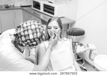 Dentist Examine Female Patient With Braces In Denal Office.