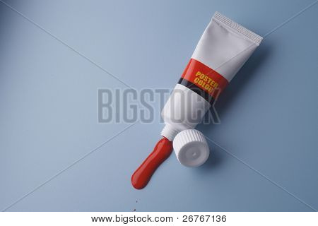 Tube of paint with some paint sqeezed out.