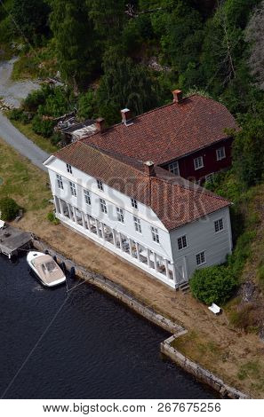 Typical Norwegian nature and houses on the shore of the fjord. View from the high bridge over the fjord. The border of Norway and Sweden.June 18,2018.Near the town Selater,Sweden