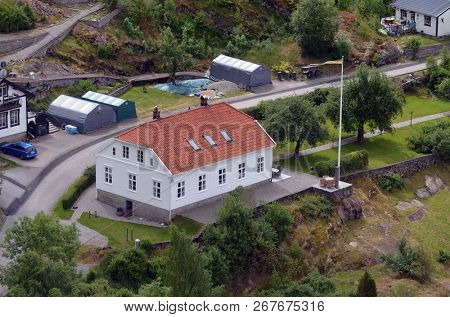 Typical Swedish nature and houses on the shore of the fjord. View from the high bridge over the fjord. The border of Norway and Sweden.June 18,2018.Near the town Selater,Sweden