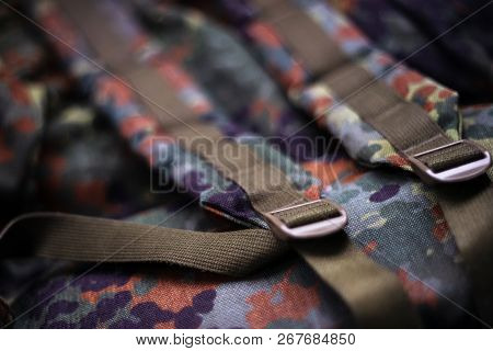 Military Camouflage Roomy Backpack. In The Frame Of The Strap And The Back Of A Backpack. Close-up V
